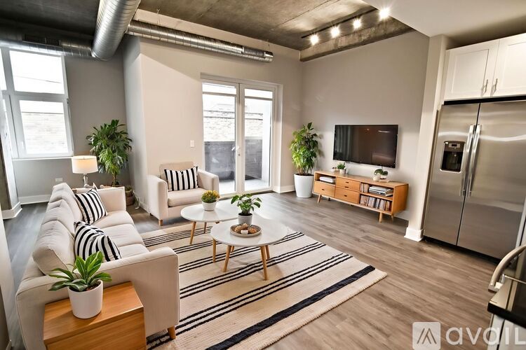 A living room with a white sofa, a wooden coffee table, and a television on a wooden stand.