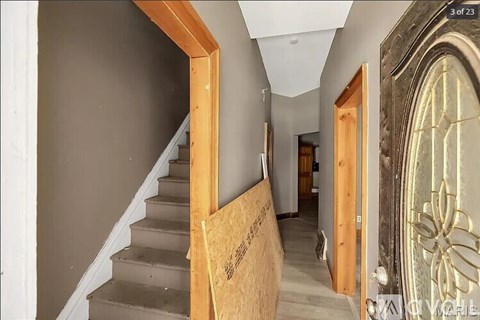 A staircase with a wooden railing and steps leading upwards.