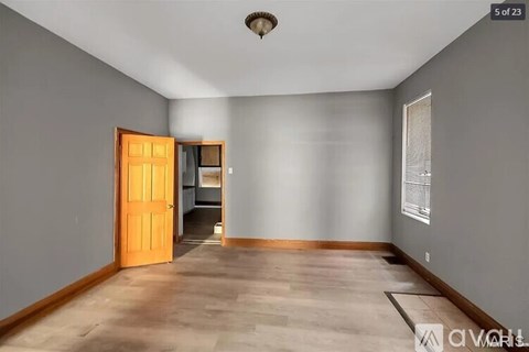 A room with a wooden floor and a ceiling light fixture.