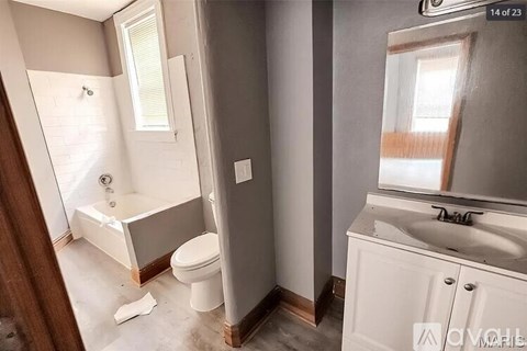 A bathroom with a white toilet, a white sink, and a white bathtub.