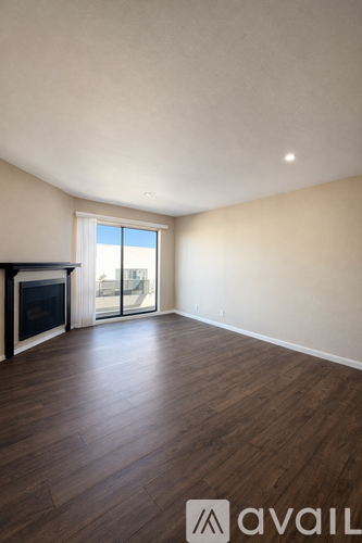 A room with a fireplace and wooden floors.