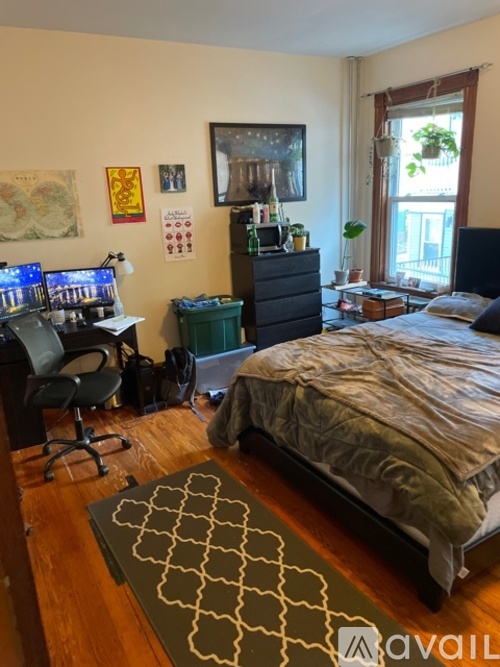 A bedroom with a bed, desk, and chair.