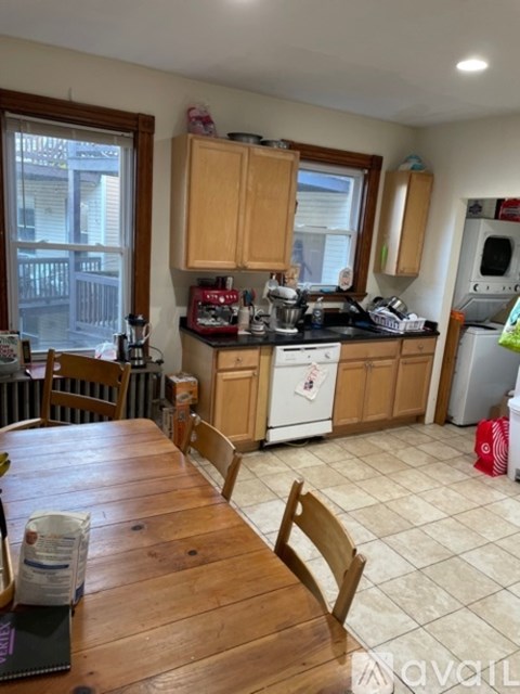 A kitchen with wooden cabinets and a white refrigerator.