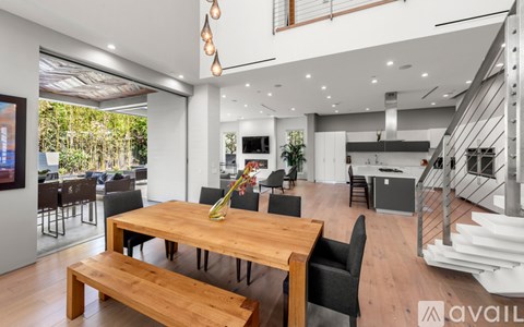 A modern dining room with a wooden table and bench.