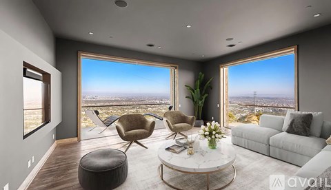 A modern living room with a view of the cityscape outside the large windows.