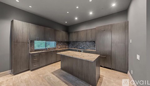 A modern kitchen with wooden cabinets and a central island.