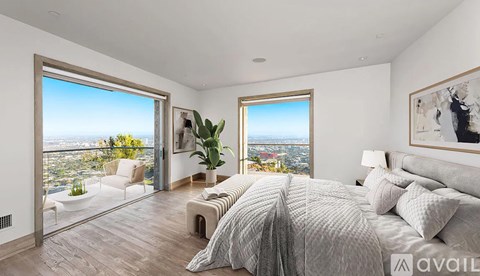 A bedroom with a large bed and a view of the city.