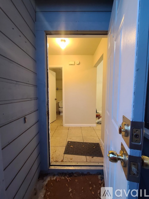 A white door with a silver handle and a small window above it.
