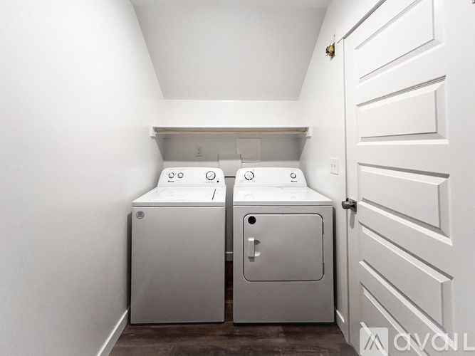 A white door is closed with a handle.