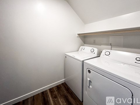 A small laundry room with a washer and dryer.
