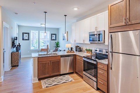 A modern kitchen with wooden cabinets and stainless steel appliances.