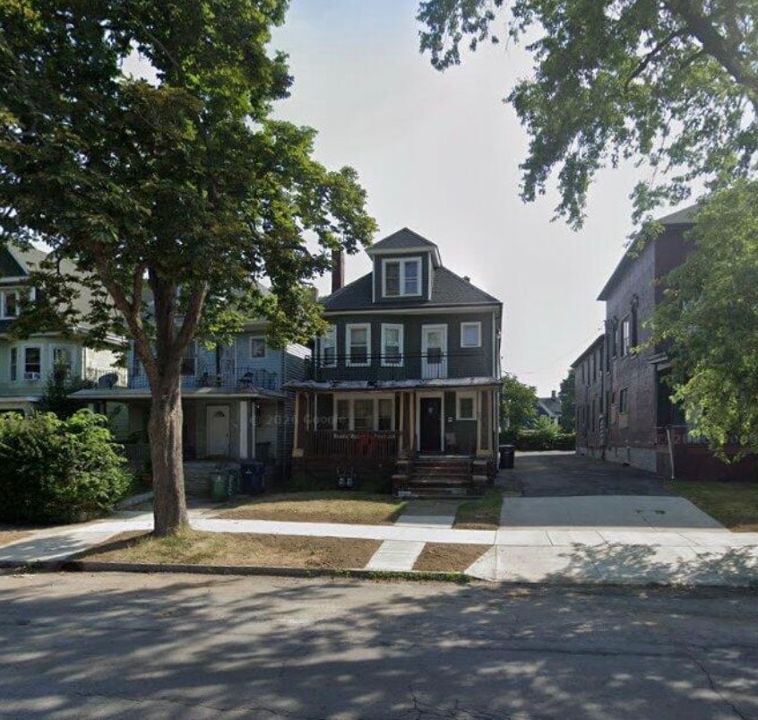 A house with a tree in front of it.