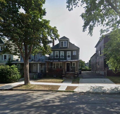 A house with a tree in front of it.