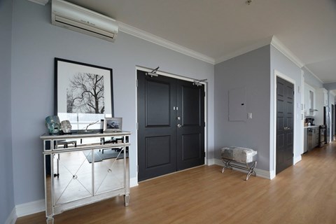 A kitchen area with a sink and a fridge.