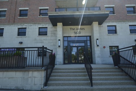 The James building has a black railing on the stairs.