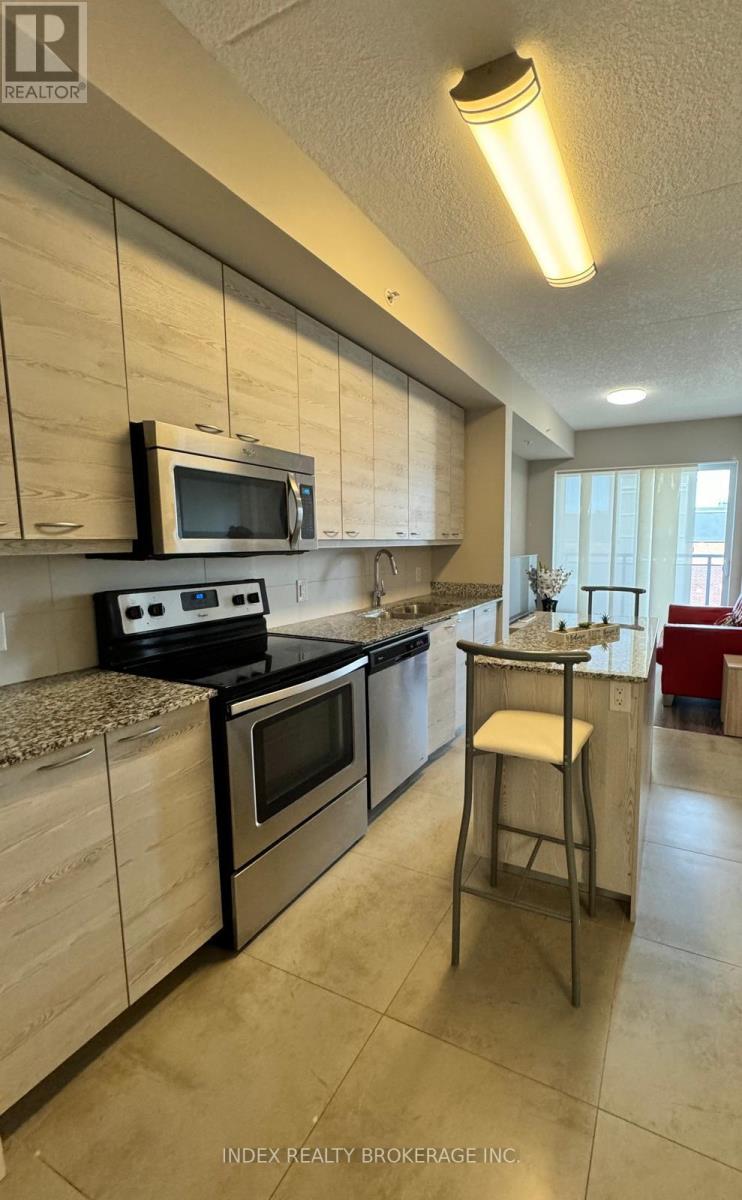 A kitchen with a microwave, oven, and stove top.