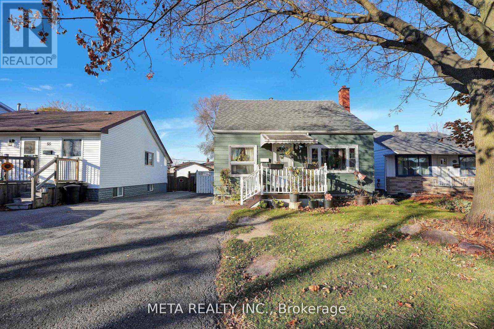 A real estate photo of a house with a sign that says Meta Realty INC Brokerage.