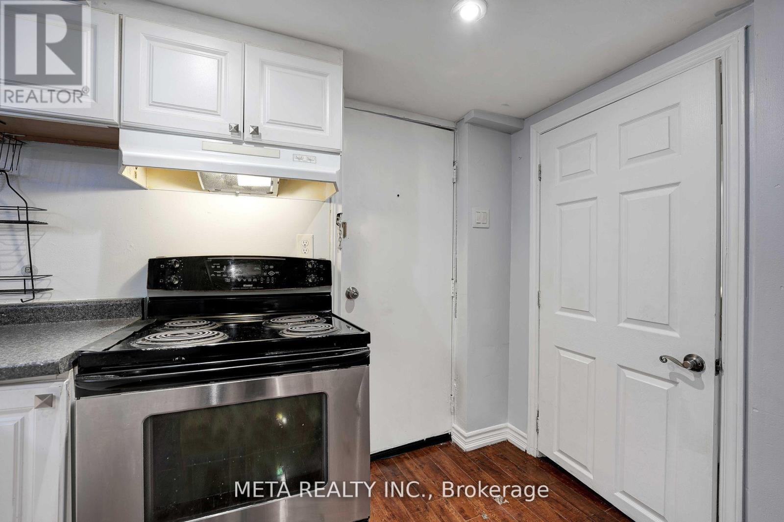 A kitchen with a stove and cabinets.