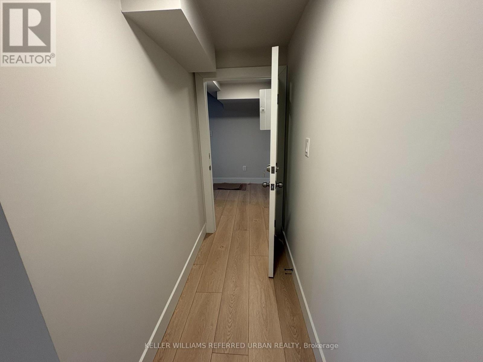 A hallway with a door at the end.