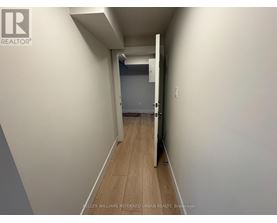 A hallway with a door at the end.