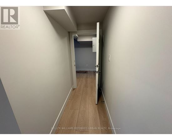 A hallway with a door at the end.