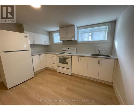 A kitchen with white appliances and cabinets.