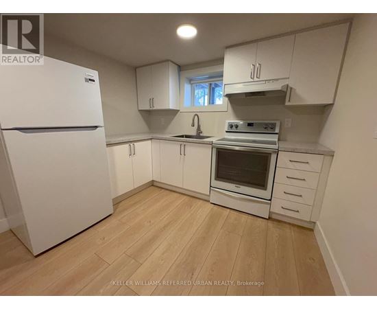 A kitchen with white appliances and cabinets.
