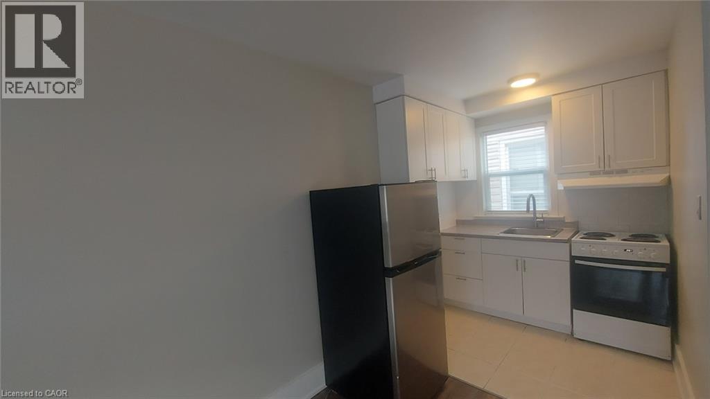 A kitchen with white cabinets and appliances.