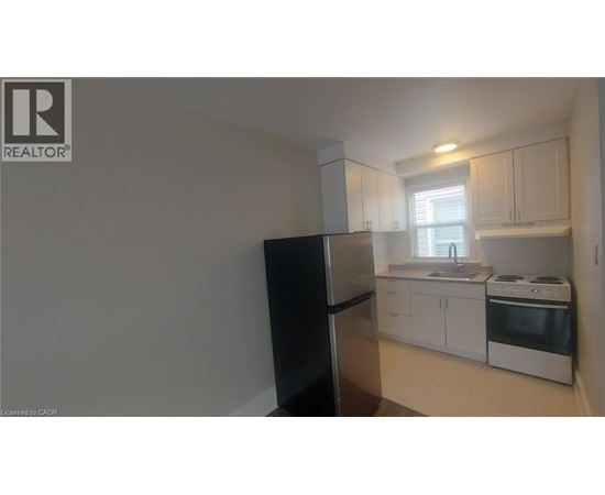 A kitchen with white cabinets and appliances.