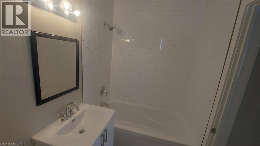 A white sink with a mirror above it in a bathroom.