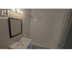 A white sink with a mirror above it in a bathroom.