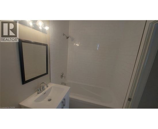 A white sink with a mirror above it in a bathroom.
