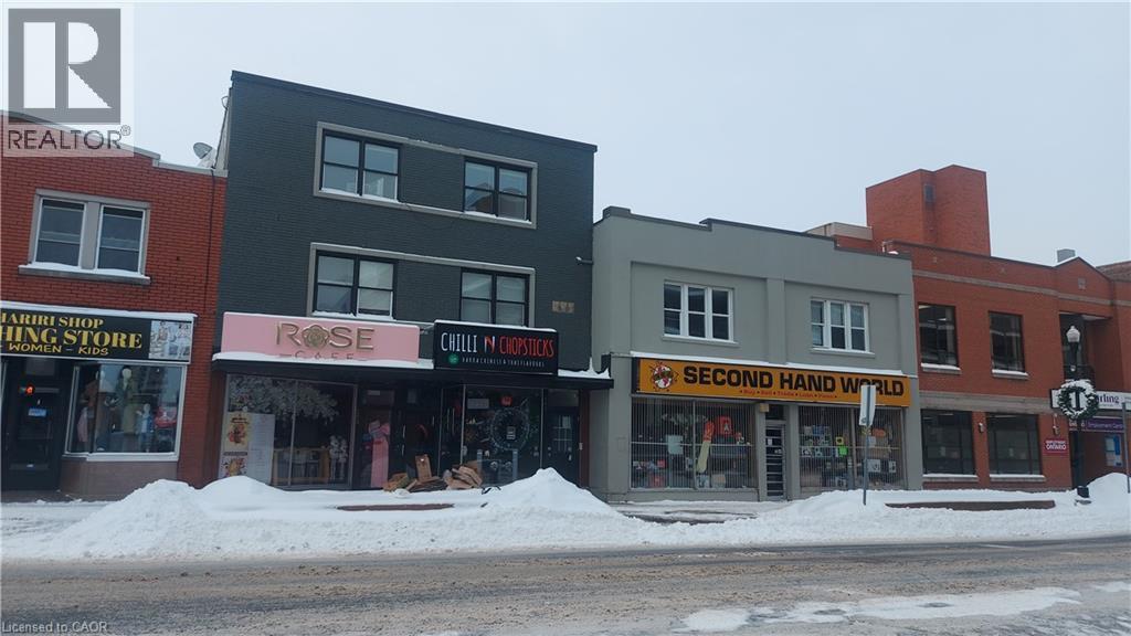 A street view of a building with a sign that reads "Second Hand Wanted".