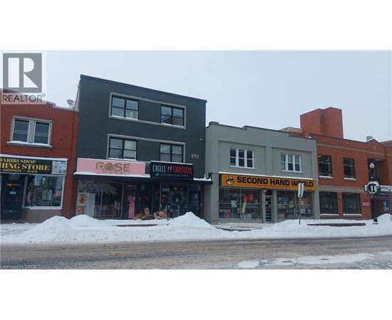 A street view of a building with a sign that reads "Second Hand Wanted".