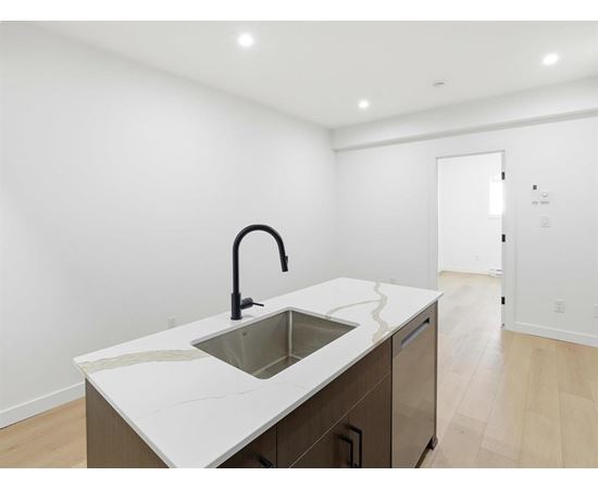 A white toilet sits next to a glass shower stall.