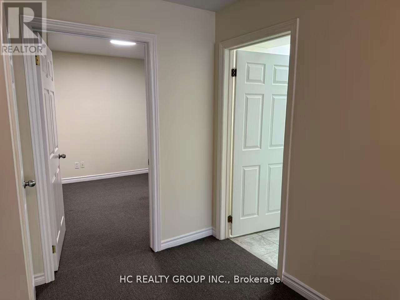 A room with a white door and a white wall.