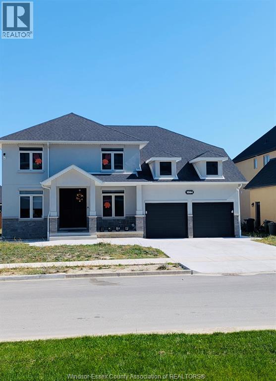 A house with a grey roof and black garage doors.