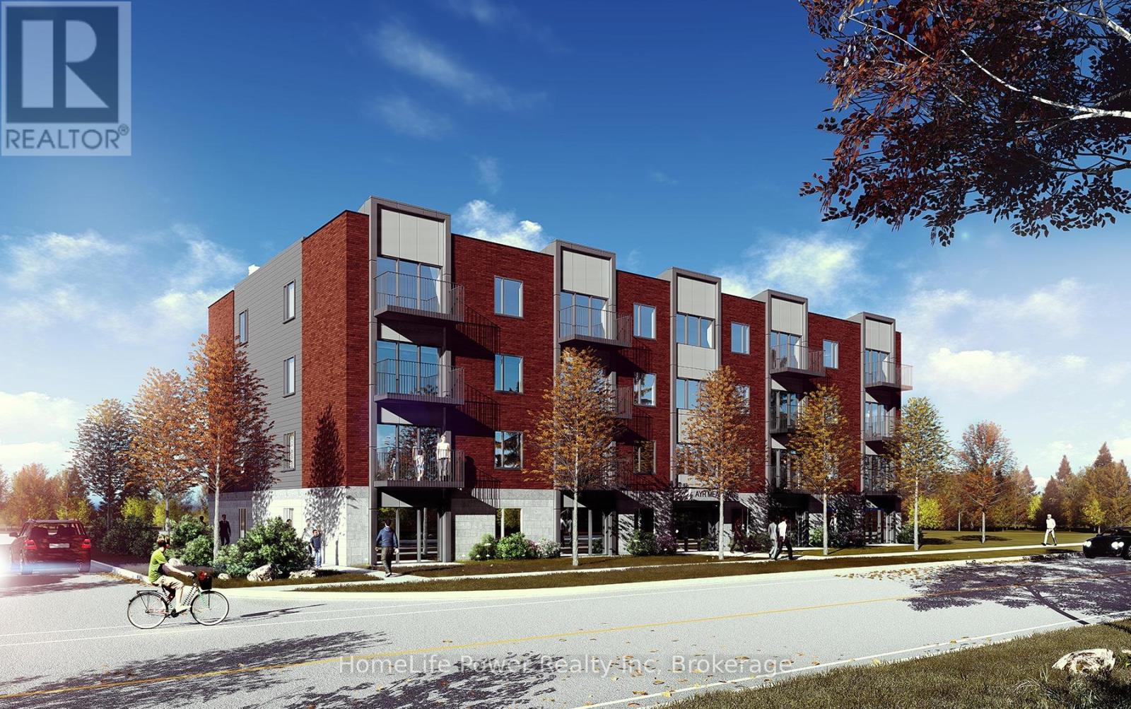 A modern apartment building with a bicycle parked in front.