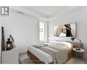 A bedroom with a bed, nightstand, and lamp.