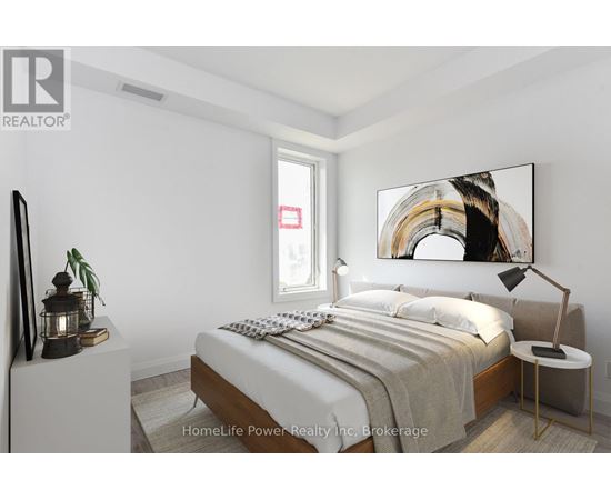 A bedroom with a bed, nightstand, and lamp.
