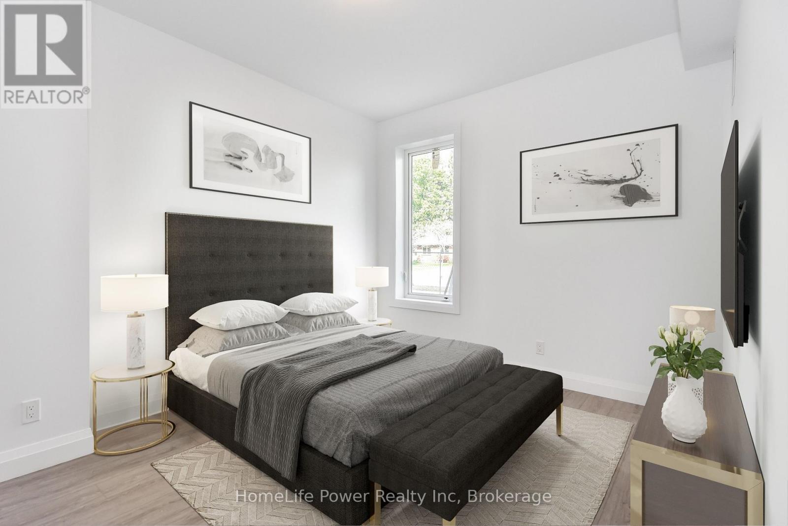 A bedroom with a large bed and a flat screen TV mounted on the wall.