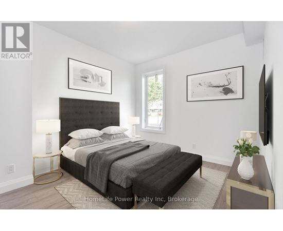 A bedroom with a large bed and a flat screen TV mounted on the wall.