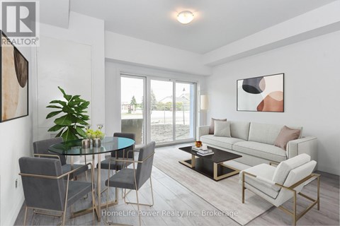 A modern living room with a glass table and grey chairs.