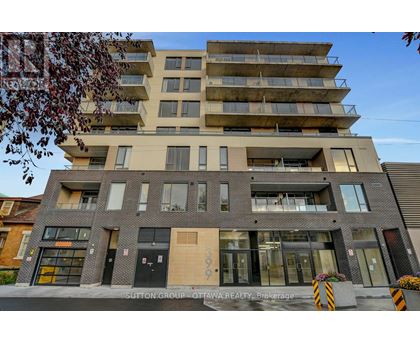A modern multi-story building with a flat roof and a mix of brick and panel facades.