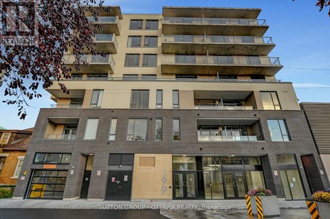 A modern multi-story building with a flat roof and a mix of brick and panel facades.