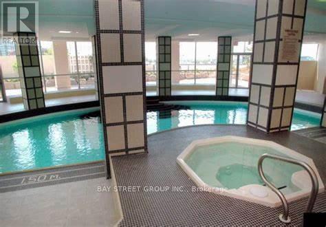 A large indoor pool with a hot tub in the middle of the room.