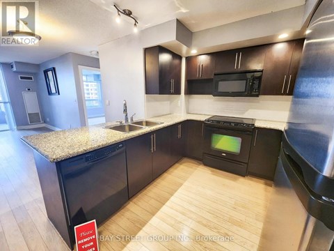 A kitchen with a granite countertop and a black oven.