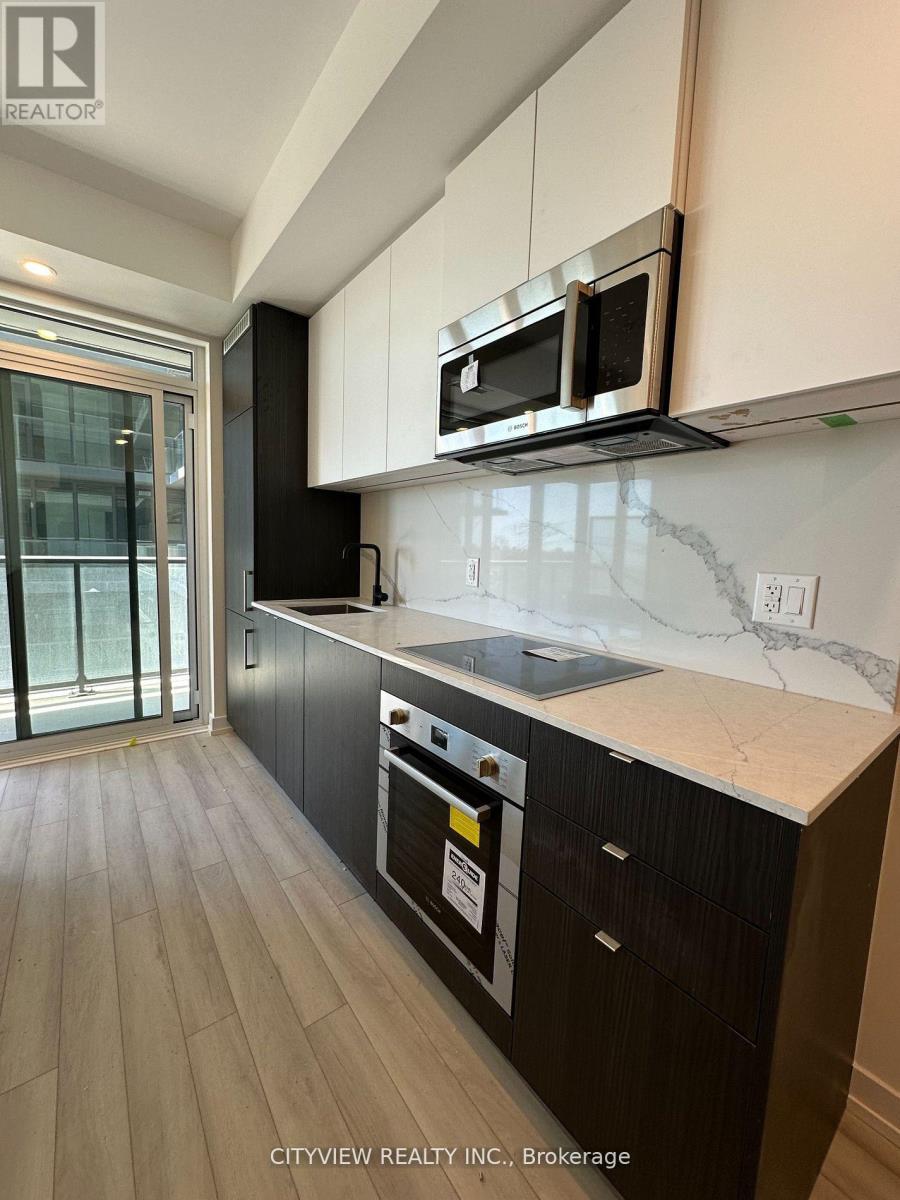 A kitchen with black cabinets and a white counter top.