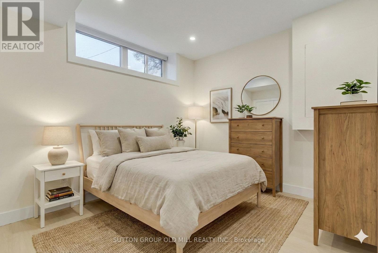 A bedroom with a bed, nightstand, and a dresser.