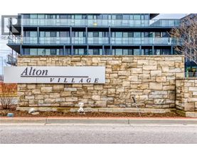 A sign that says Alton Village in front of a building.